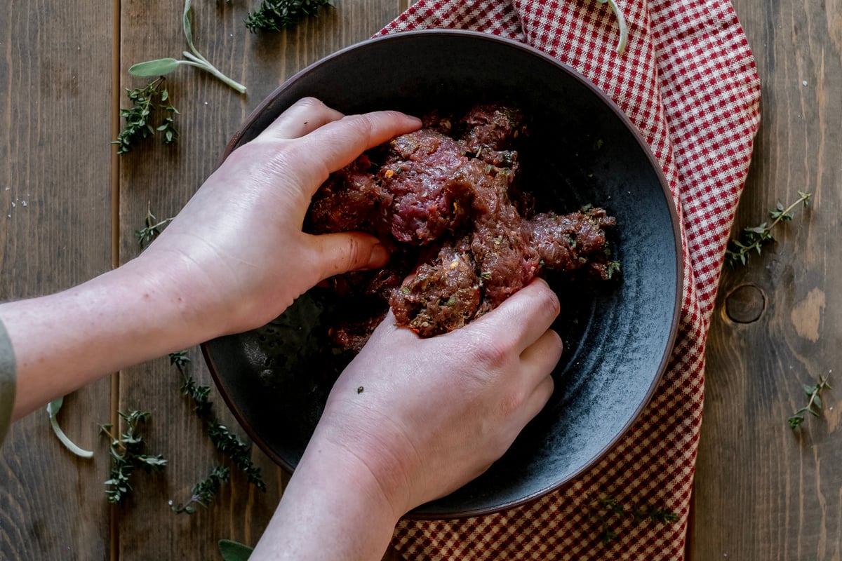 mixing antelope breakfast sausage by hand.