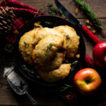 hand pies on black plate with apple and thyme.