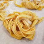 homemade tagliatelle nest on paper.