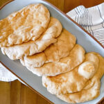 pieces of flatbread on blue platter.