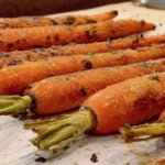 roasted carrots with ginger on parchment paper.