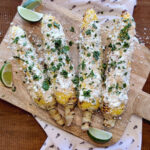 sweet corn elotes on wood board.
