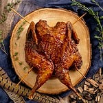 smoked pheasant on wood slice.