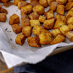 brioche garlic croutons on parchment paper.