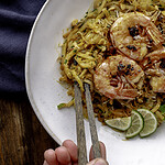 chopsticks grabbing bite from bowl of kohlrabi noodles.