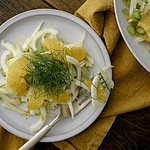 fennel orange salad on white plate with bite on fork.