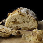 roasted garlic sourdough with 2 slices on wood board.
