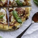 4 pieces of sourdough margherita pizza with sauce spoon.