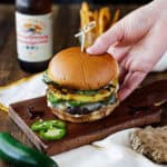 hand holding teriyaki elk burger.