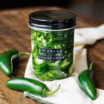 quick pickled jalapenos in labeled jar.