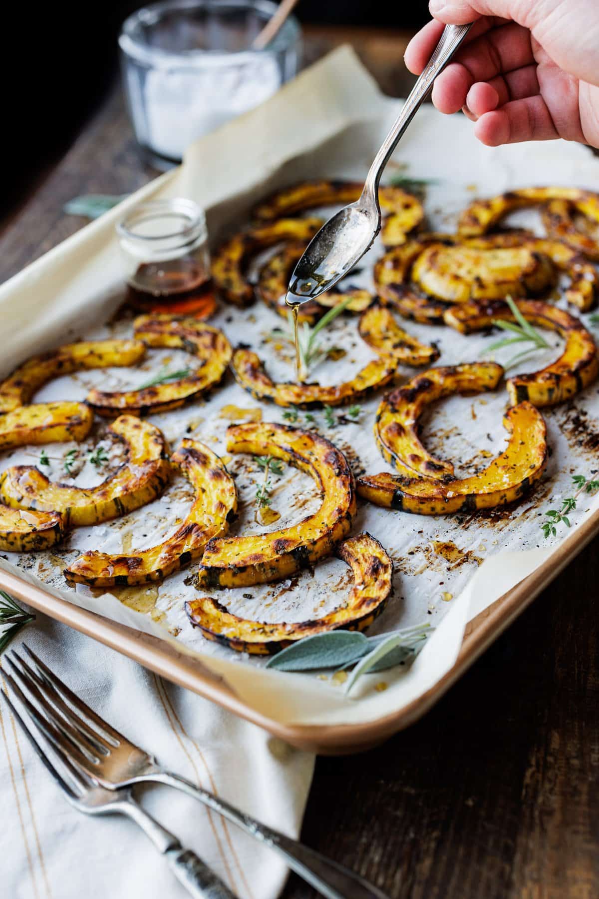 drizzling maple syrup over roasted delicata squash.