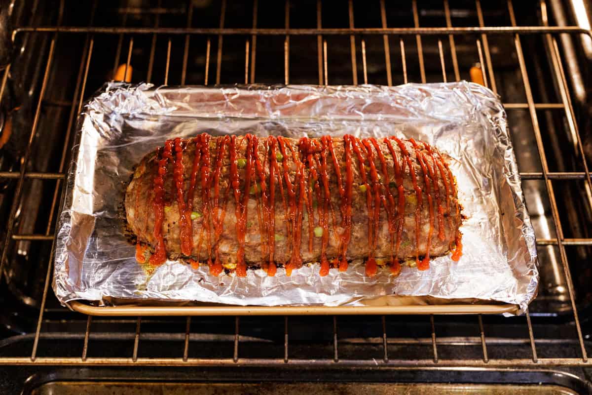 elk meatloaf with ketchup in oven.