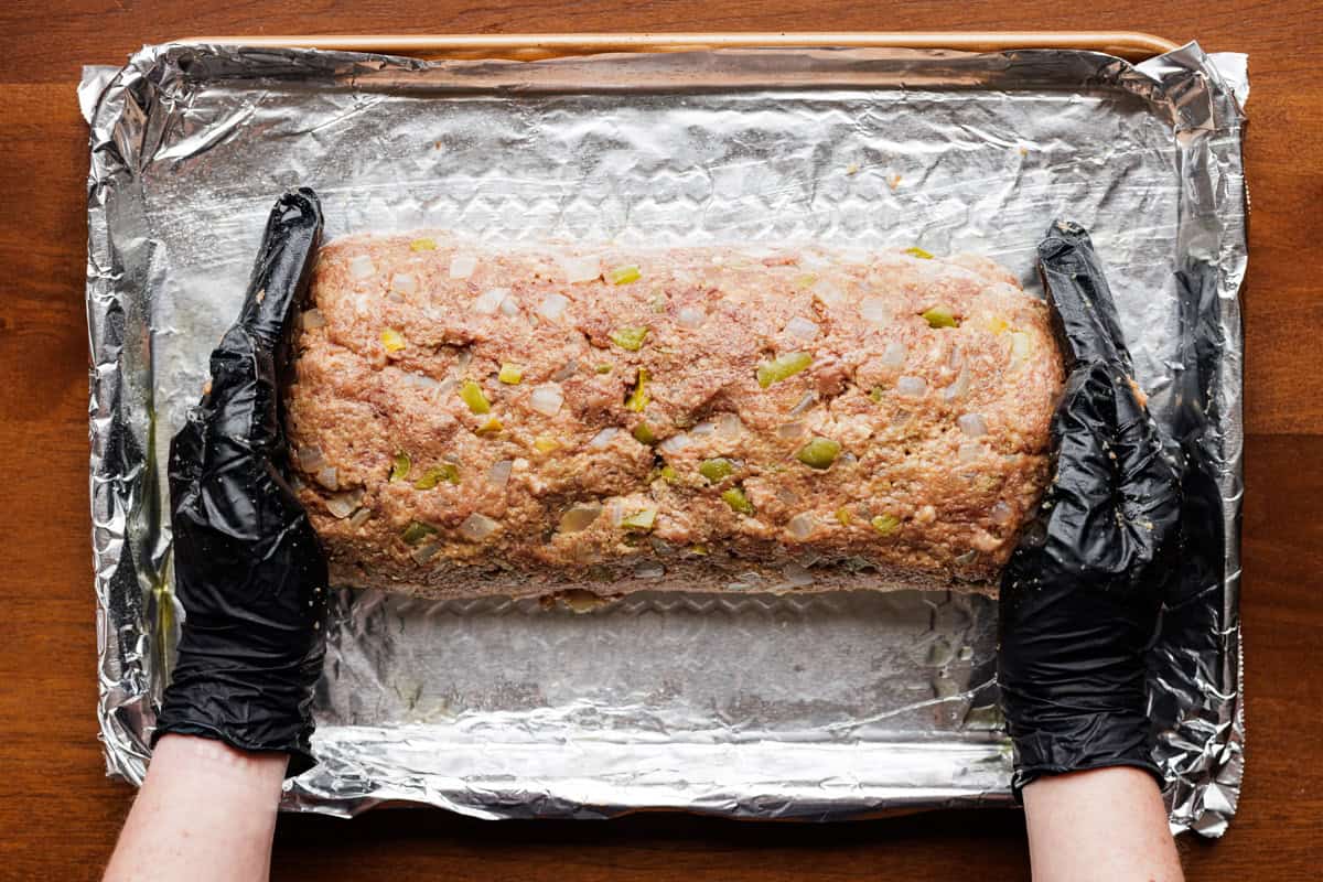 shaping elk meatloaf with hands.