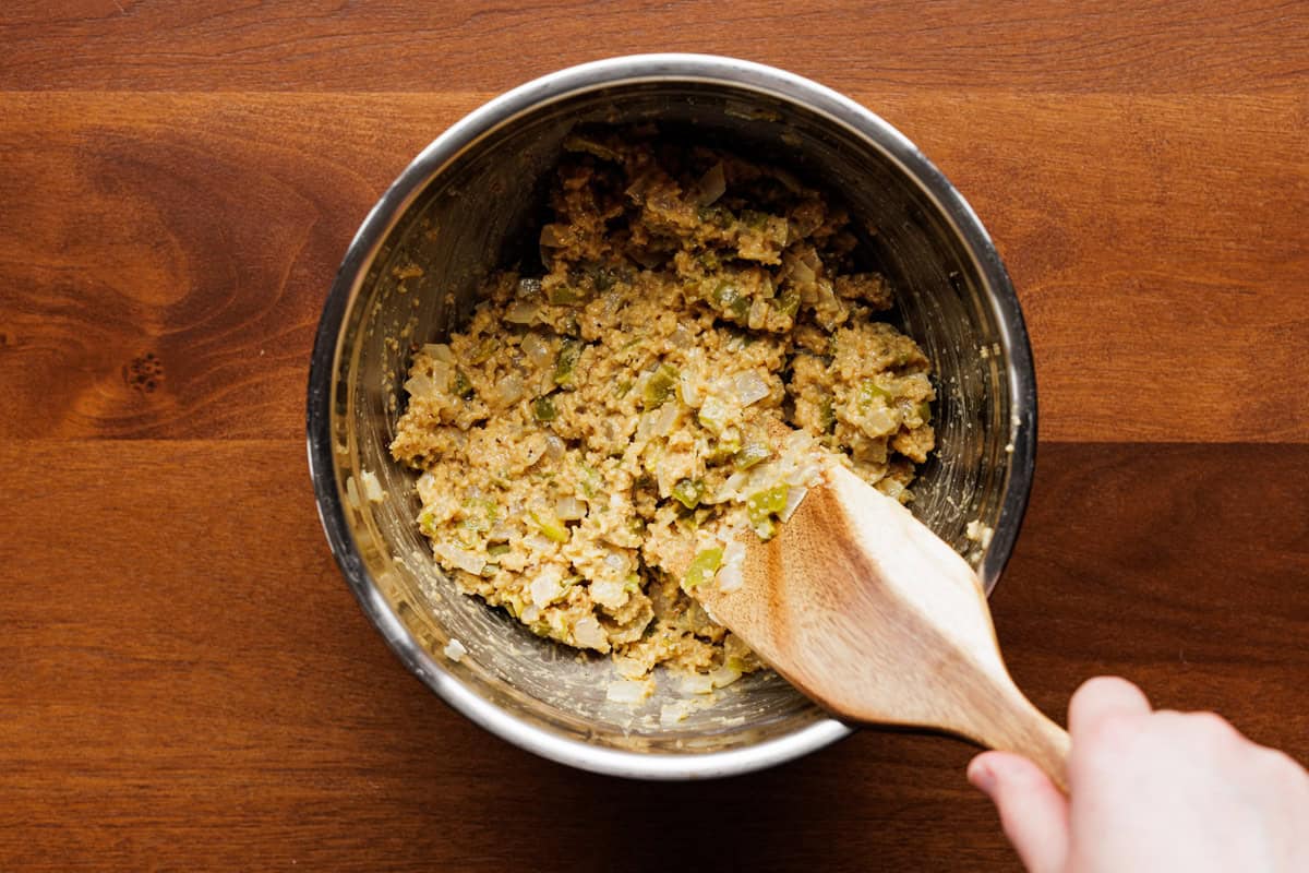 stirring meatloaf ingredients in bowl.
