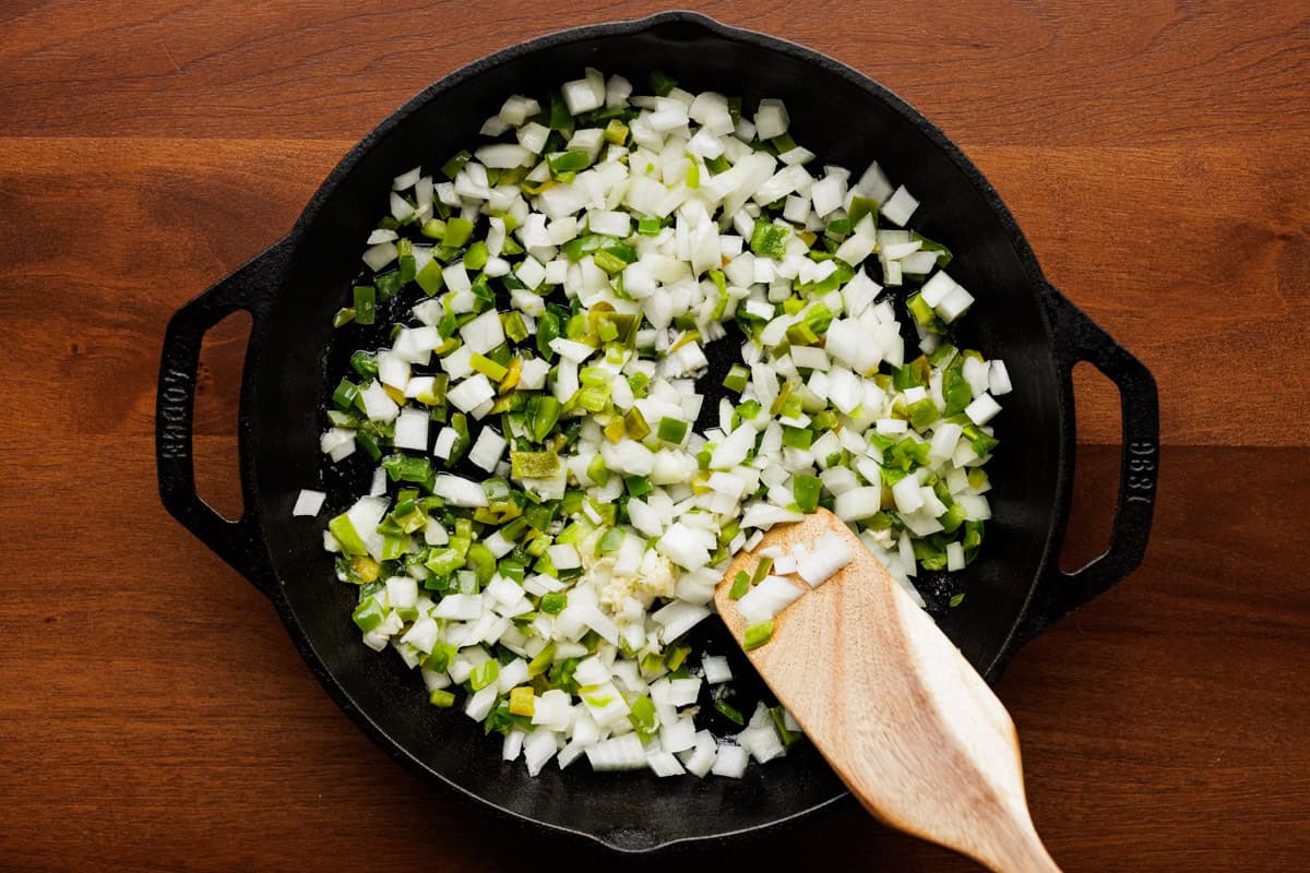 stirring peppers and onions in pan.