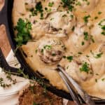 swedish elk meatballs with mushrooms in pan.