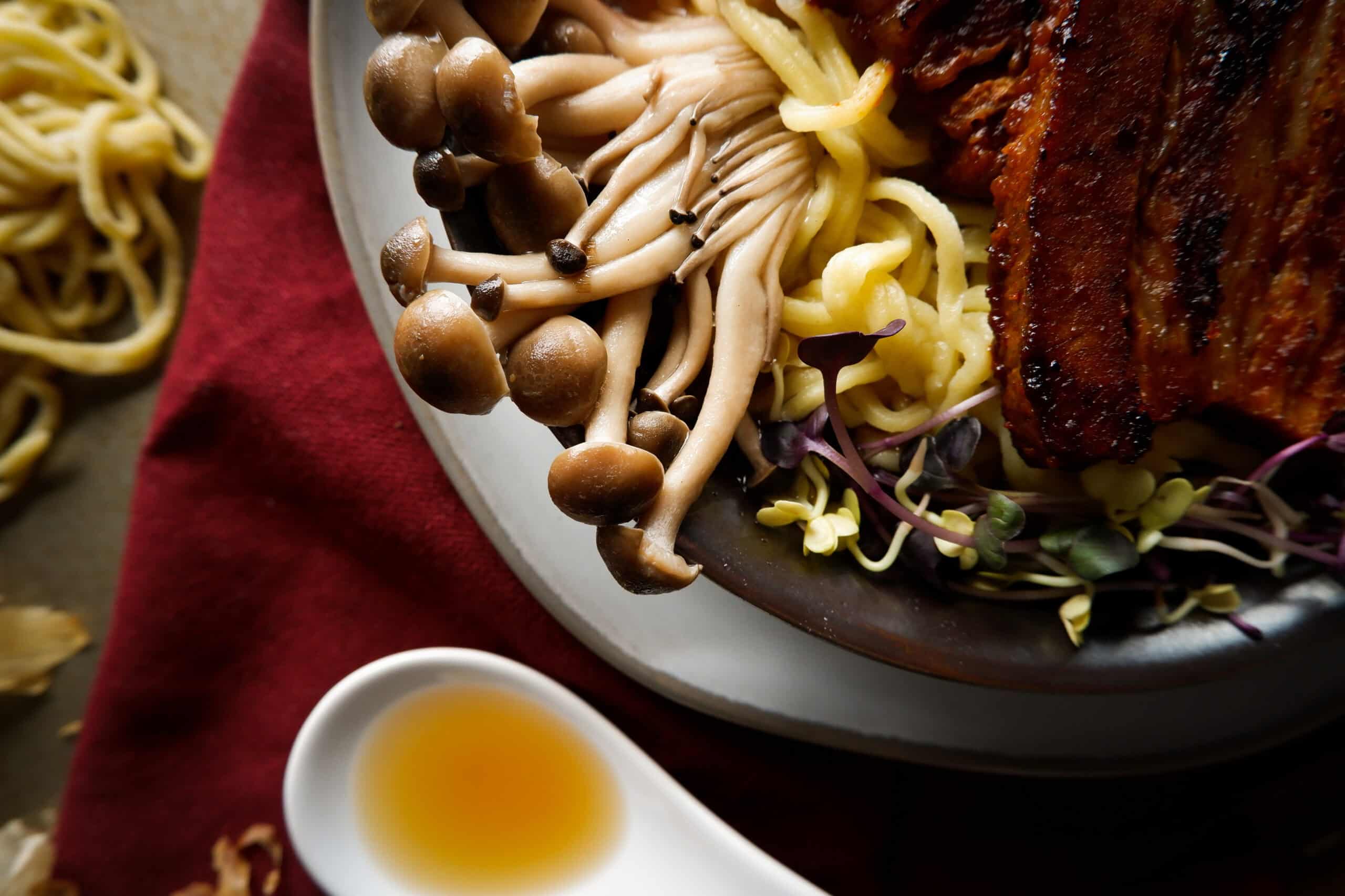 brown clamshell mushrooms in bowl of ramen.