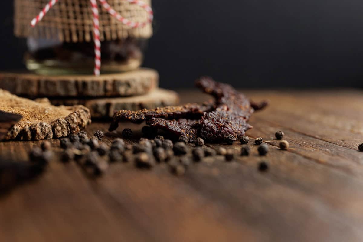 peppercorns on wood with jerky.