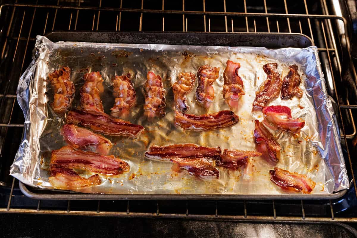 bacon slices cooking in oven.