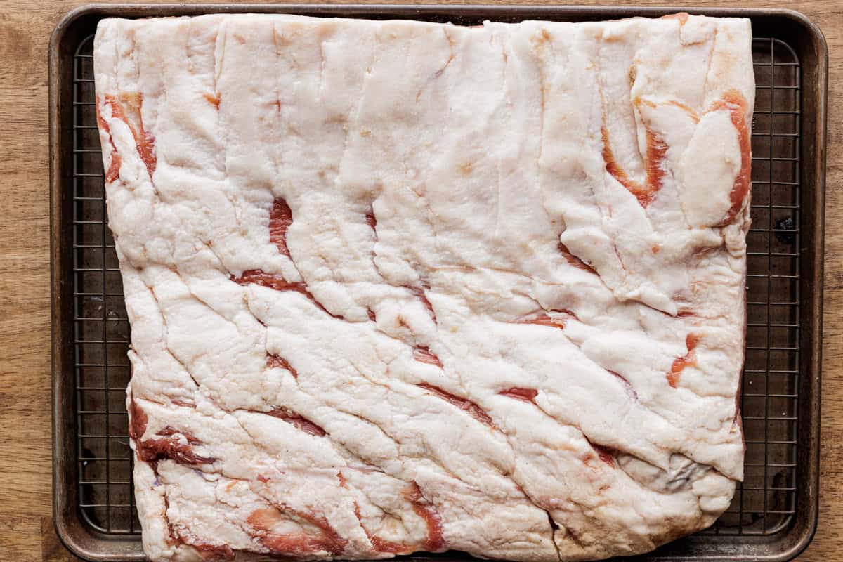 cured pork belly on wire rack.