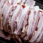 slices of homemade smoked bacon in pile.