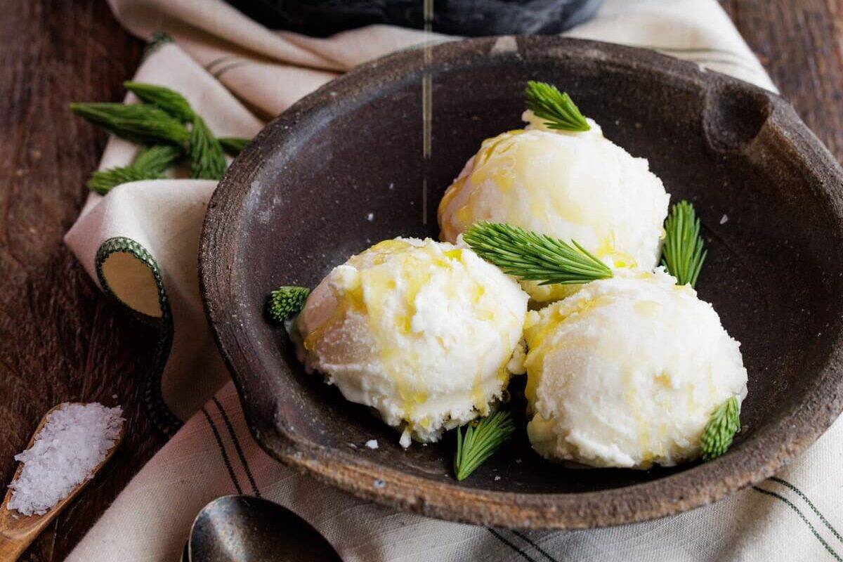 drizzling olive oil over spruce tip ice cream.
