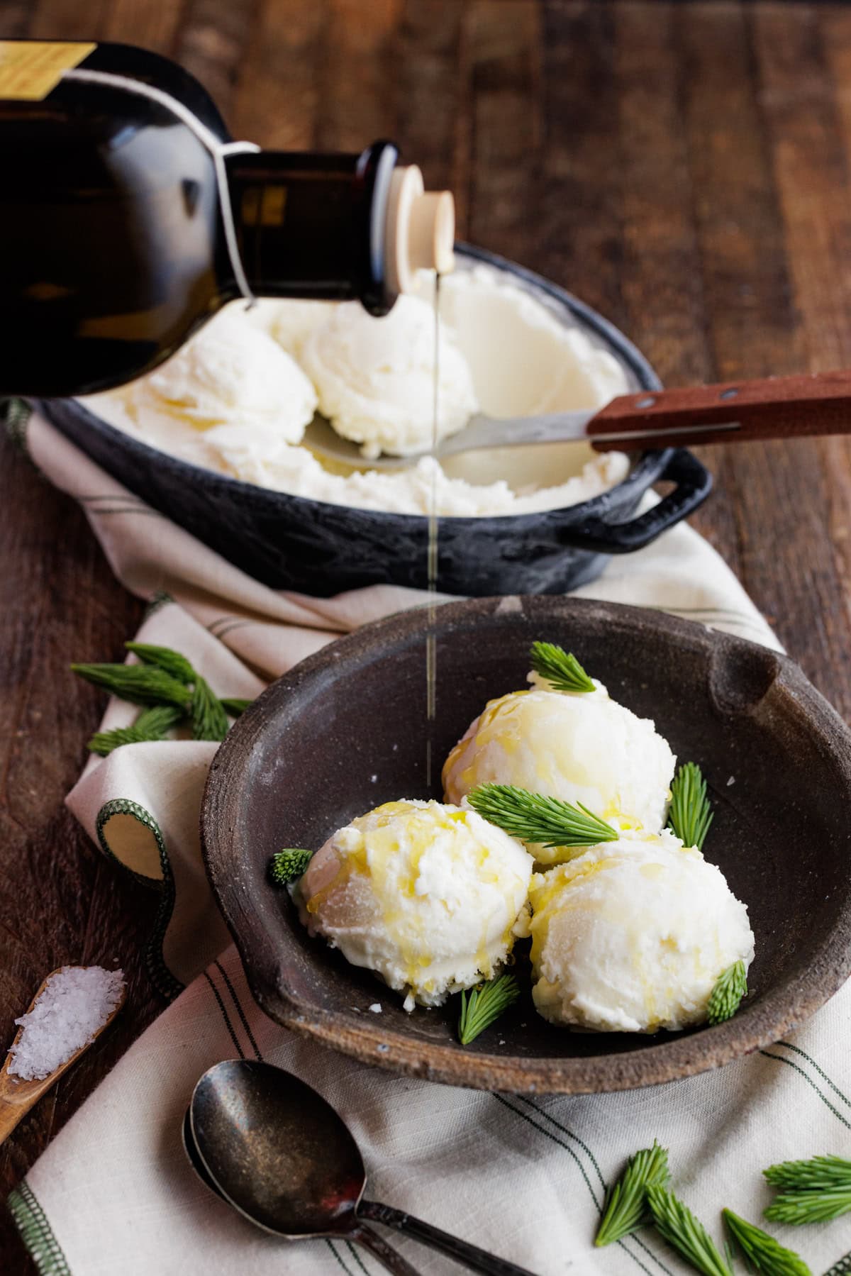 drizzling olive oil over spruce tip ice cream.