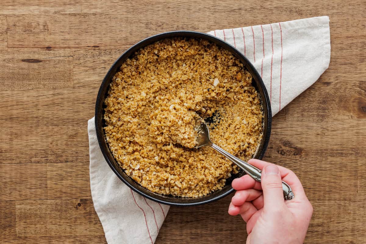 stirring olive oil into breadcrumbs.