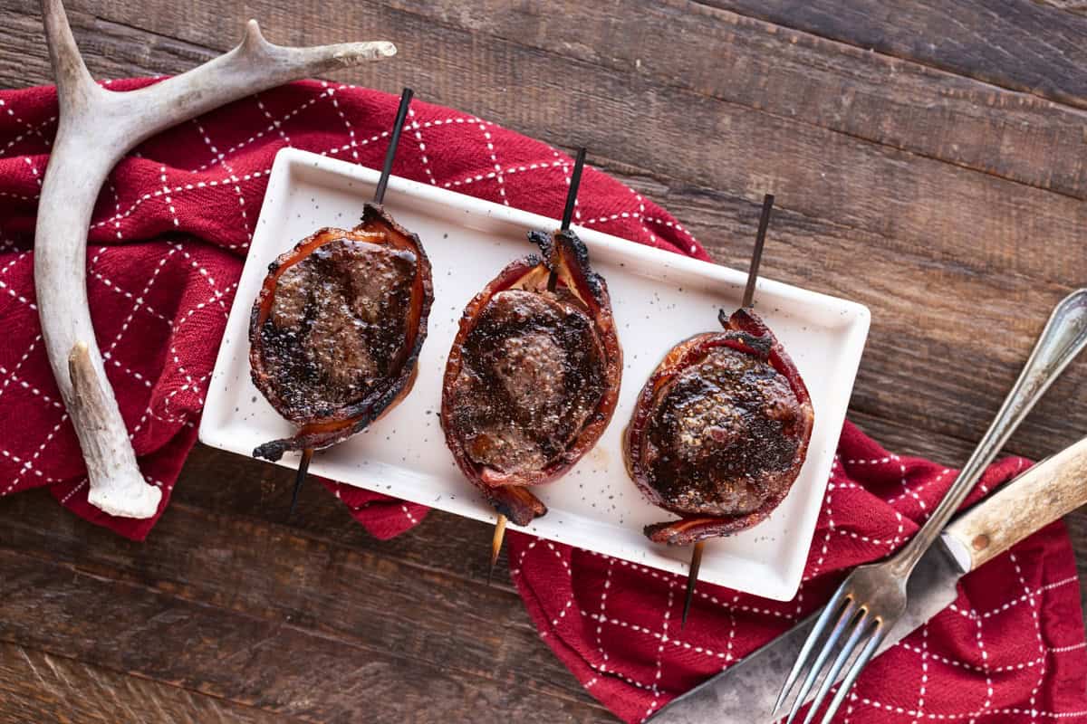 3 bacon wrapped venison backstrap medallions.