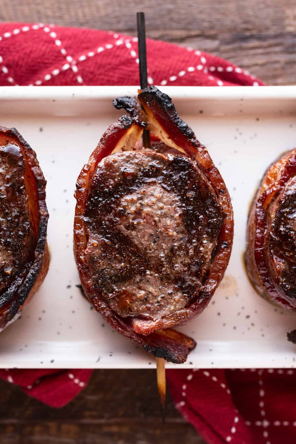bacon-wrapped venison backstrap medallion on plate.