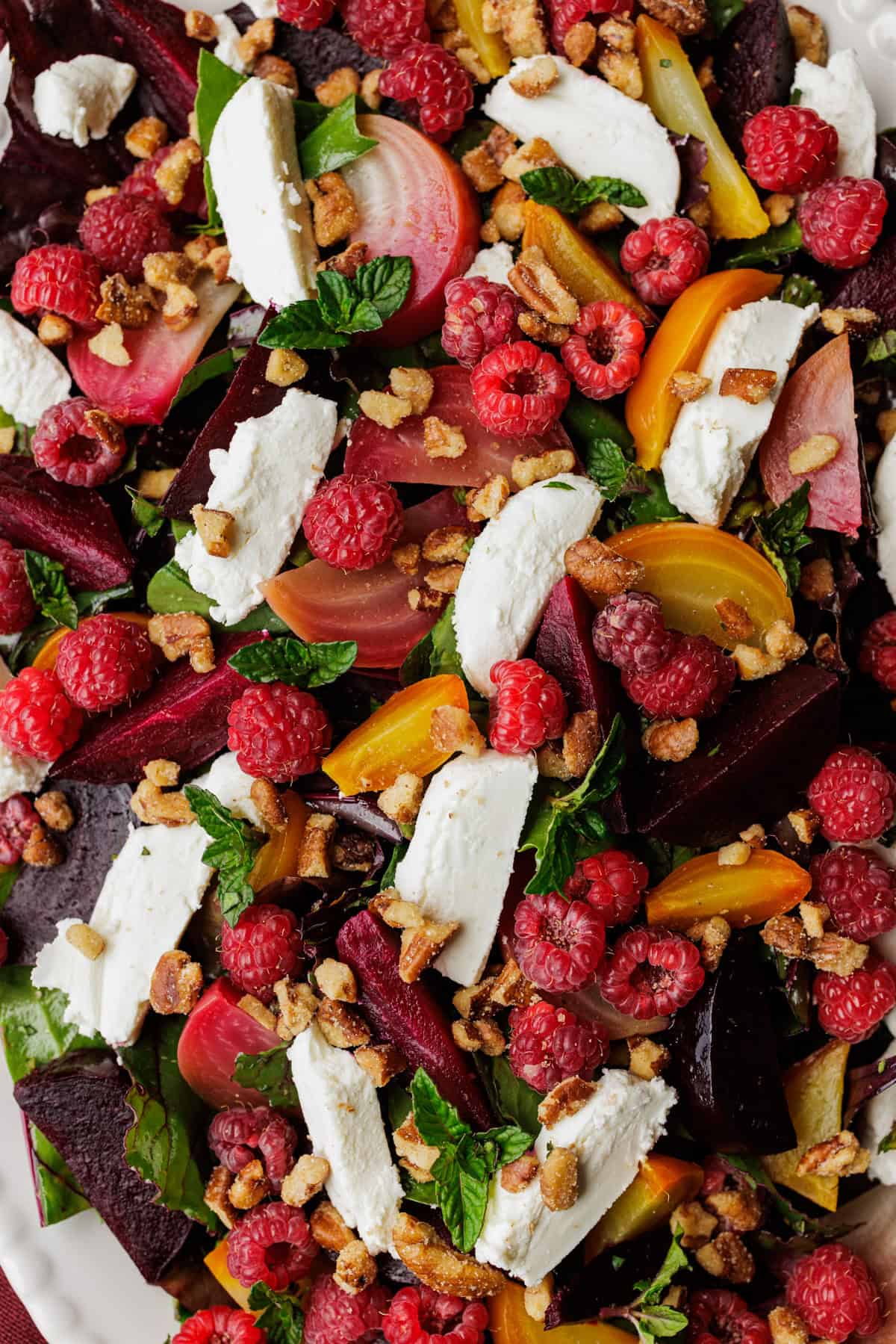 roasted beet salad with slices of goat cheese, raspberries, and chopped mint.