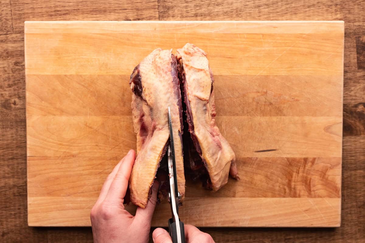 cutting backbone out of duck.