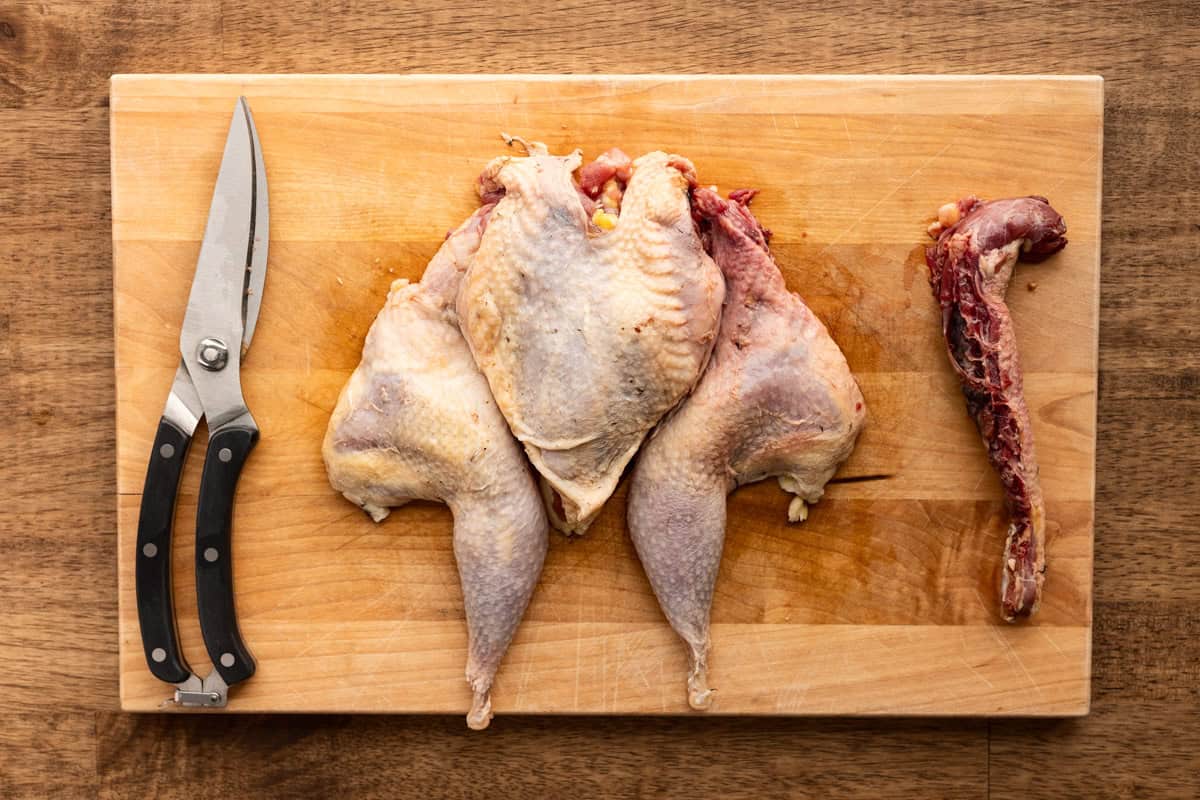 spatchcocked pheasant on cutting board.