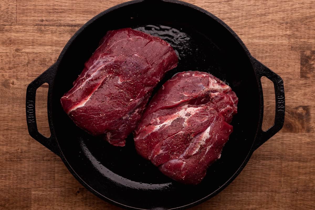 elk neck roast in cast iron skillet.