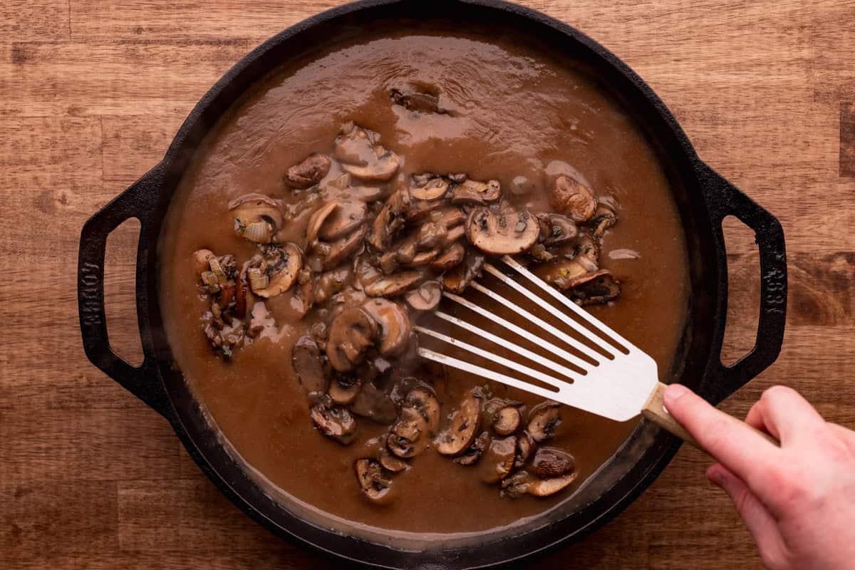 stirring mushrooms into elk roast gravy.