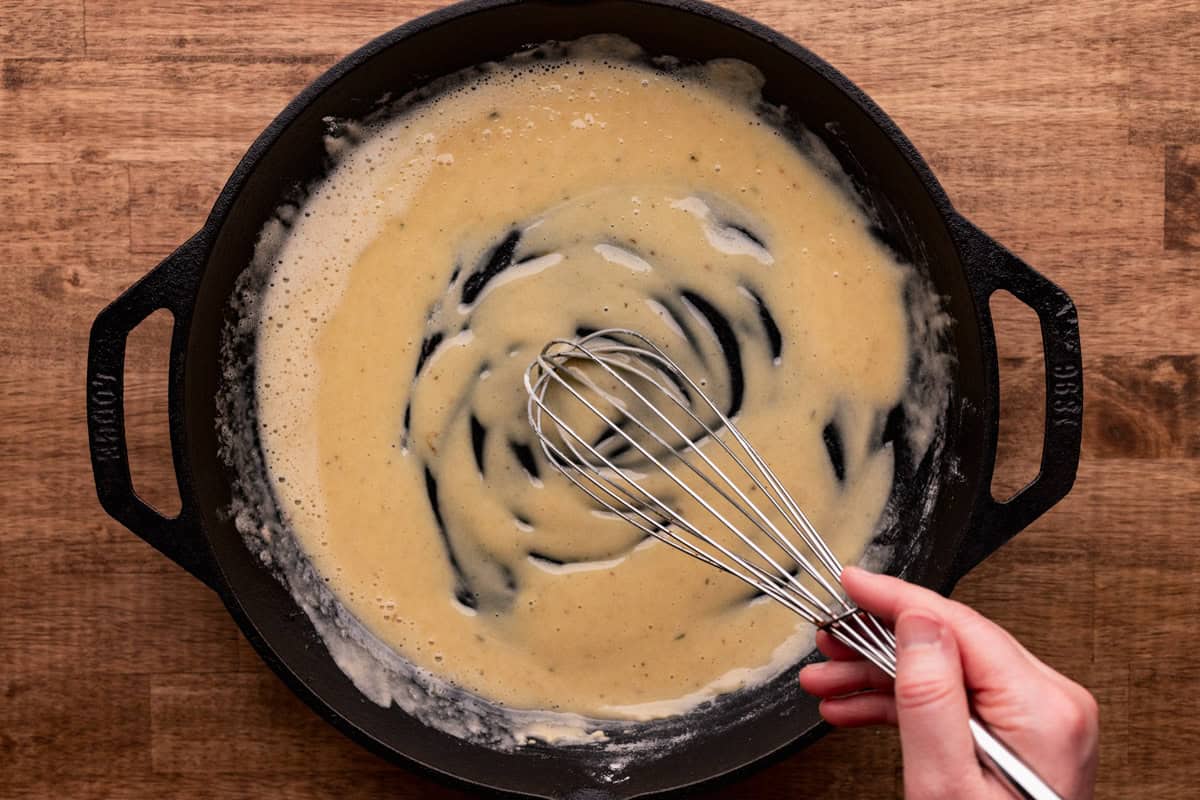 whisking roux in skillet.