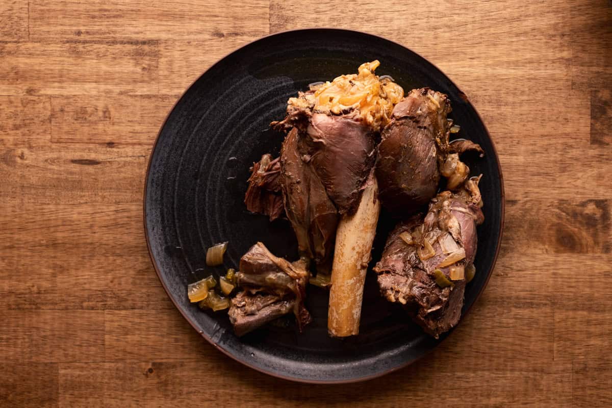 cooked venison shank on plate.