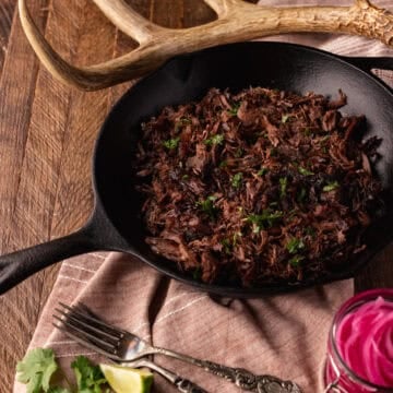 venison shank carnitas in skillet.
