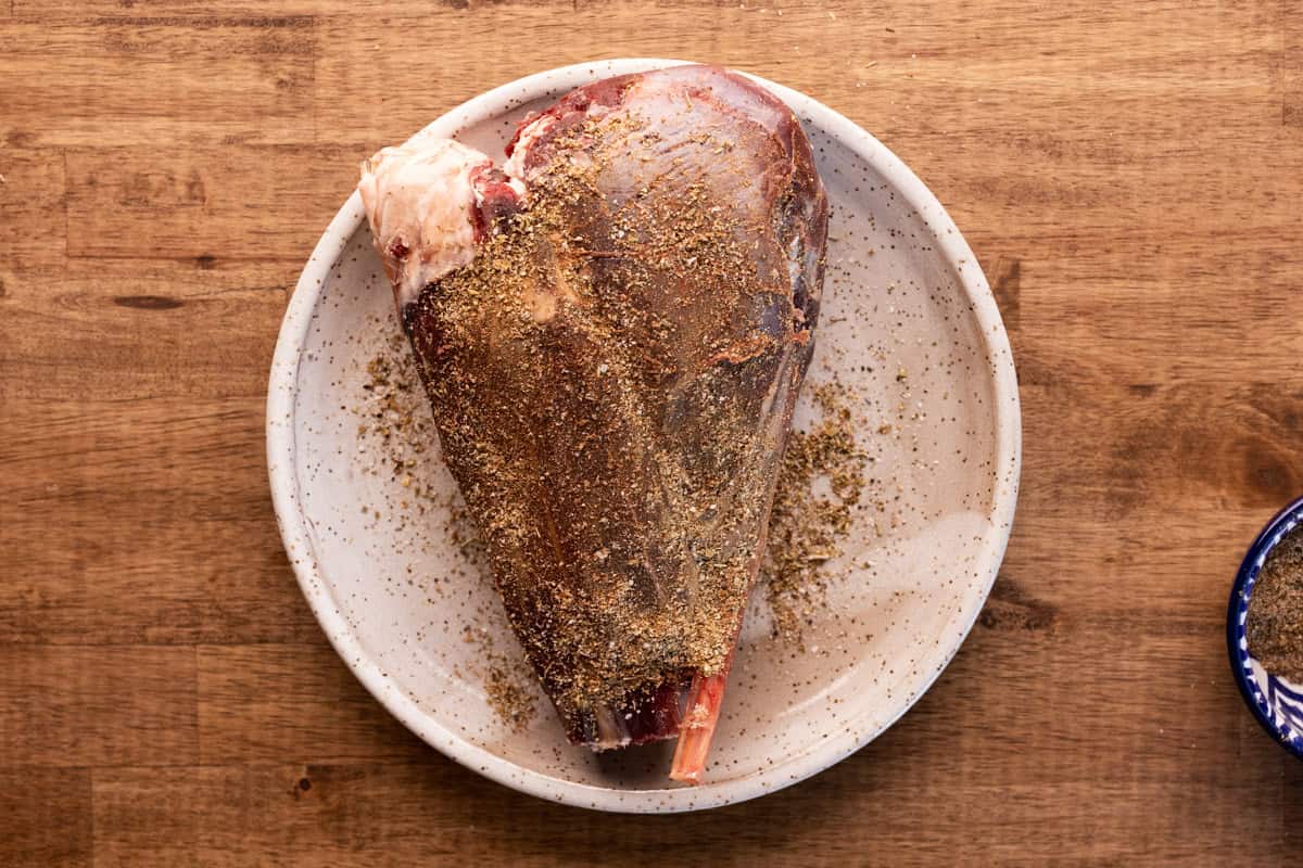 venison shank covered in spice mixture.