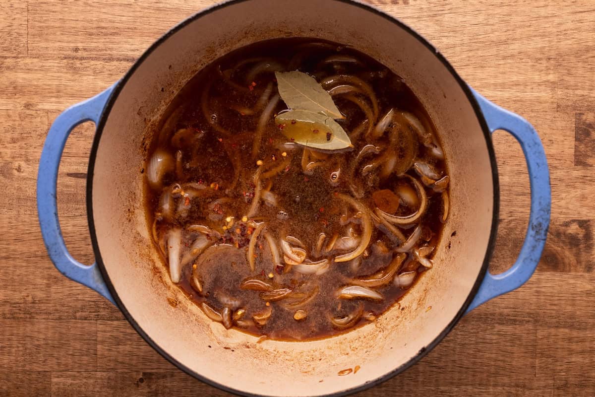 adobo marinade with onions in dutch oven.