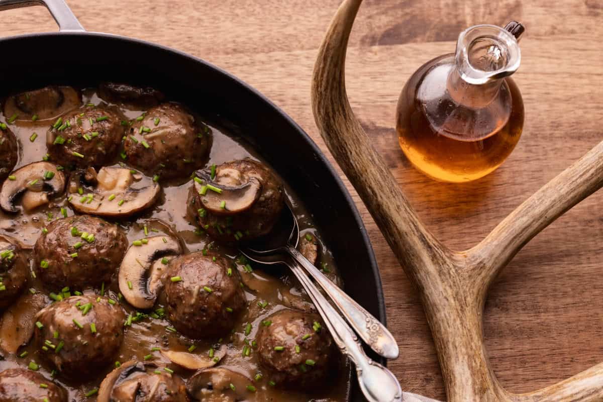 venison meatballs on spoons in marsala sauce.