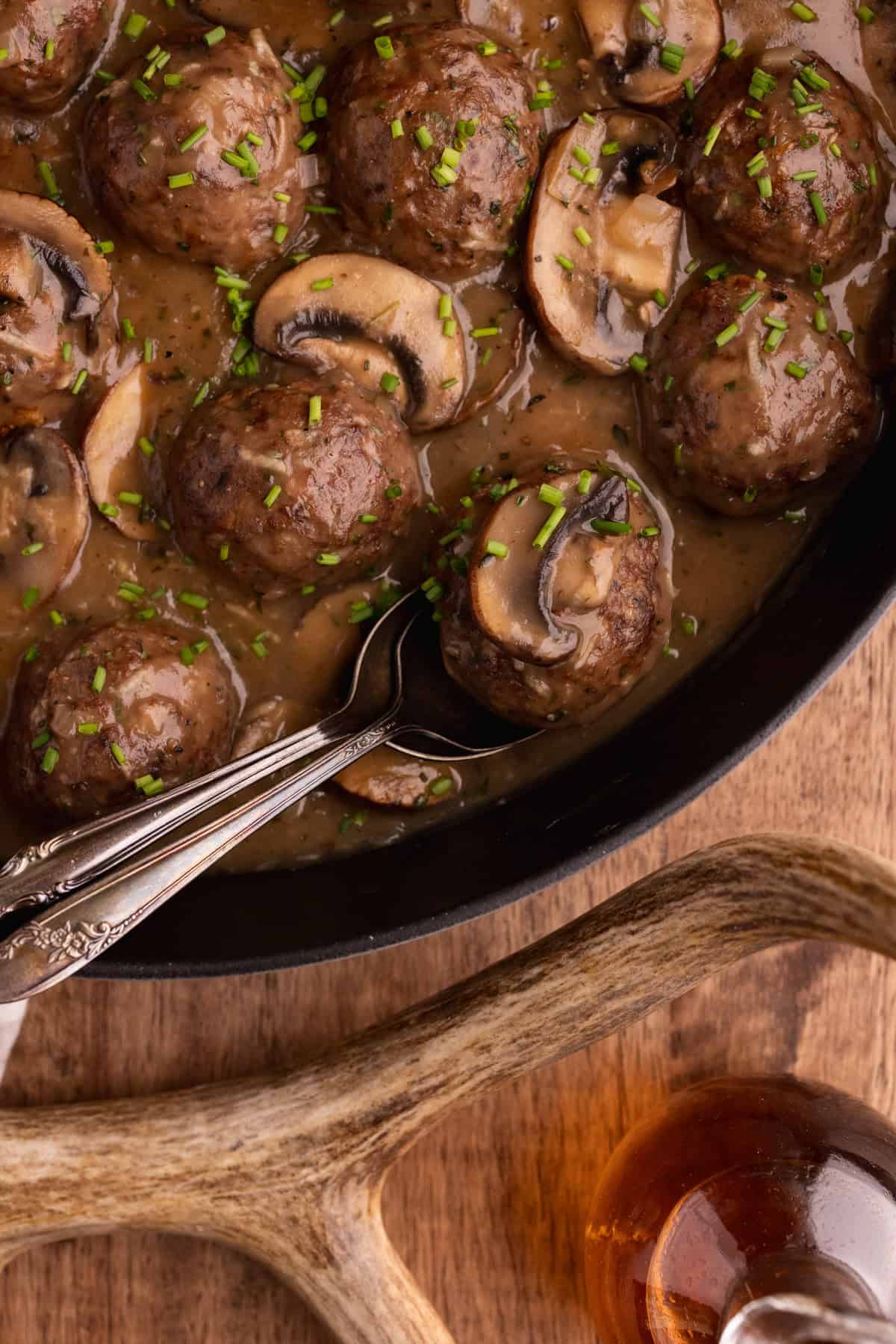 venison meatballs with marsala sauce in skillet.