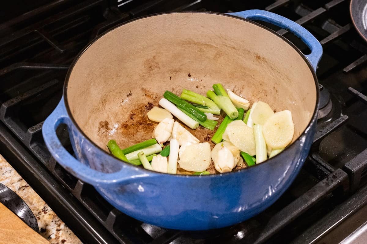 green onions and ginger in dutch oven.