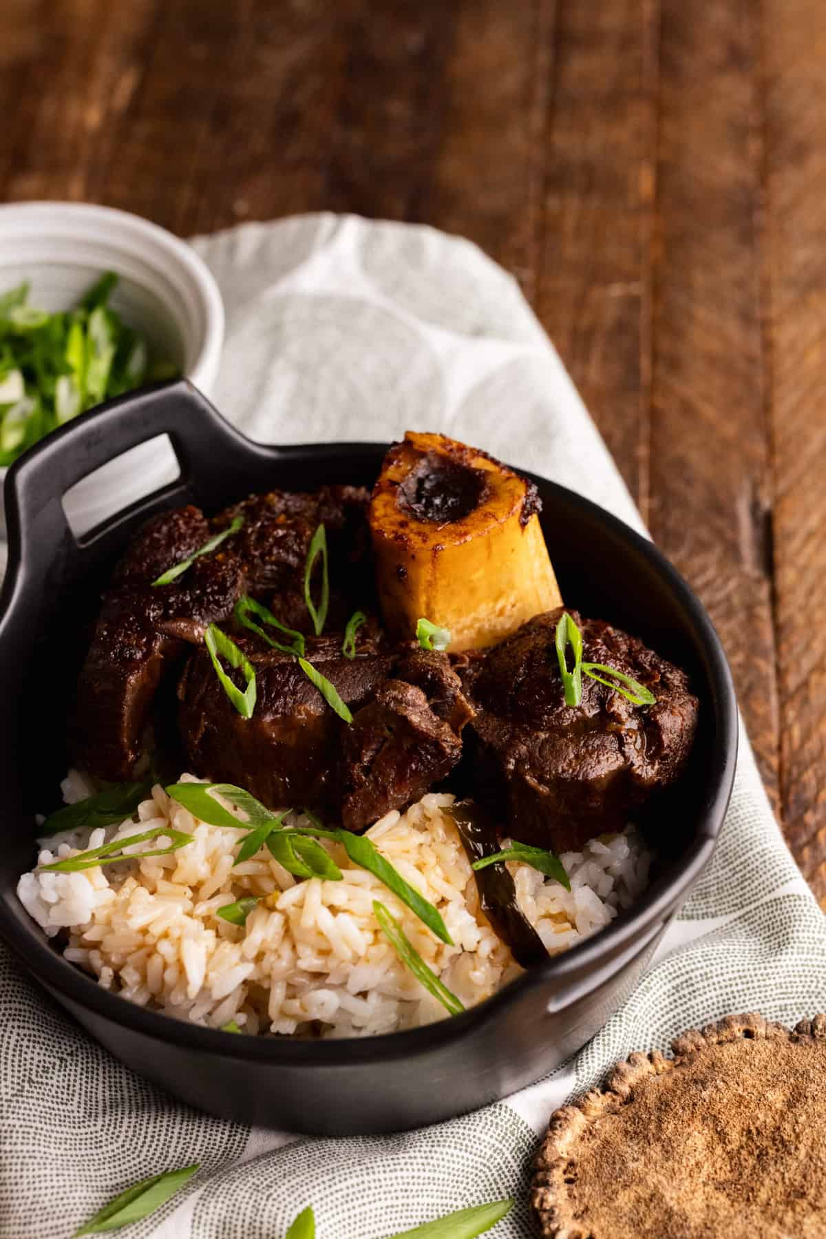 soy braised elk shank osso buco in bowl with rice.