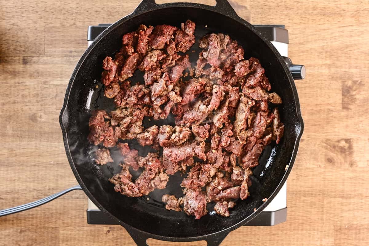 venison taco meat cooking in pan.