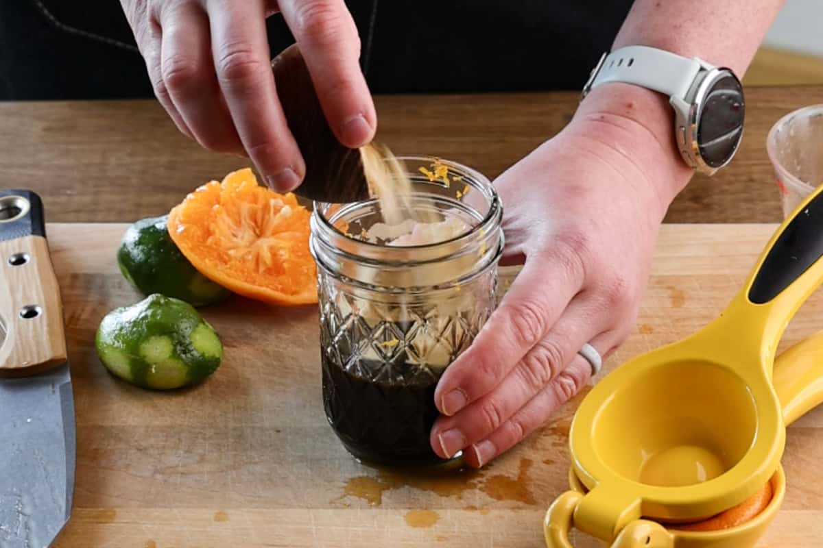 pouring bonito flakes into ponzu jar.