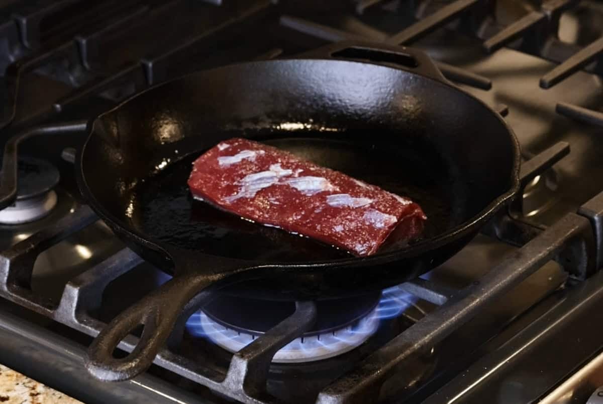 searing venison backstrap in pan.