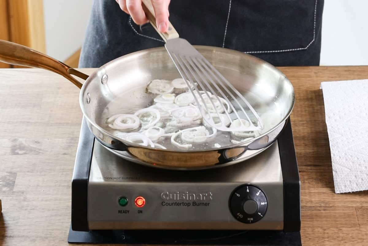 shallots cooking in pan.