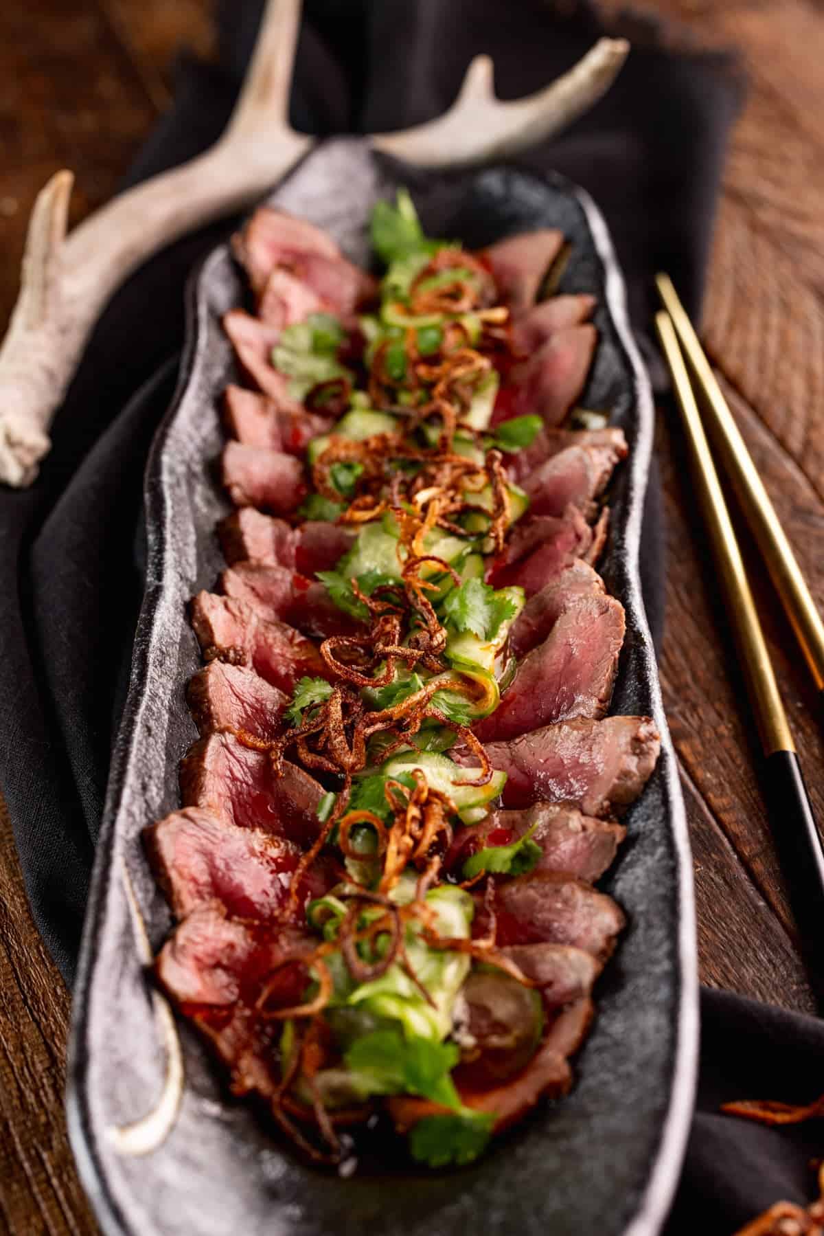 venison tataki with crispy shallots.