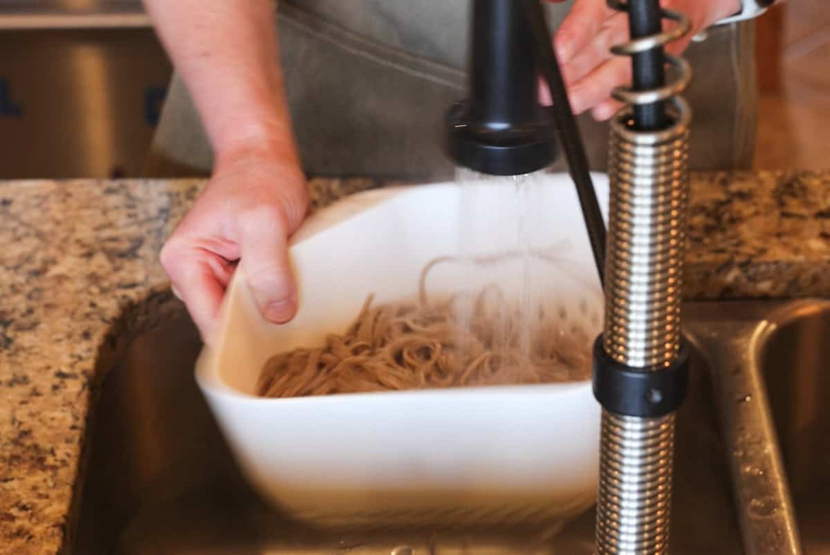 rinsing soba noodles.